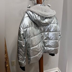 Silver puffer jacket on faux fur with hoodie and wind protective sleeves